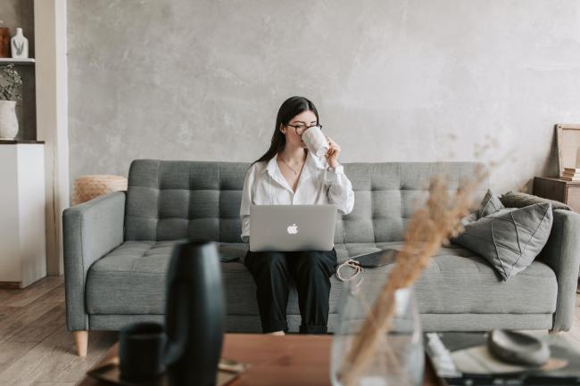 Woman with laptop on couch